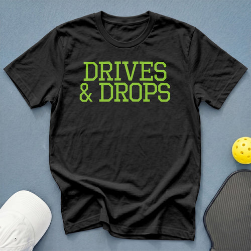 Black t-shirt with green text that says "DRIVES & DROPS".