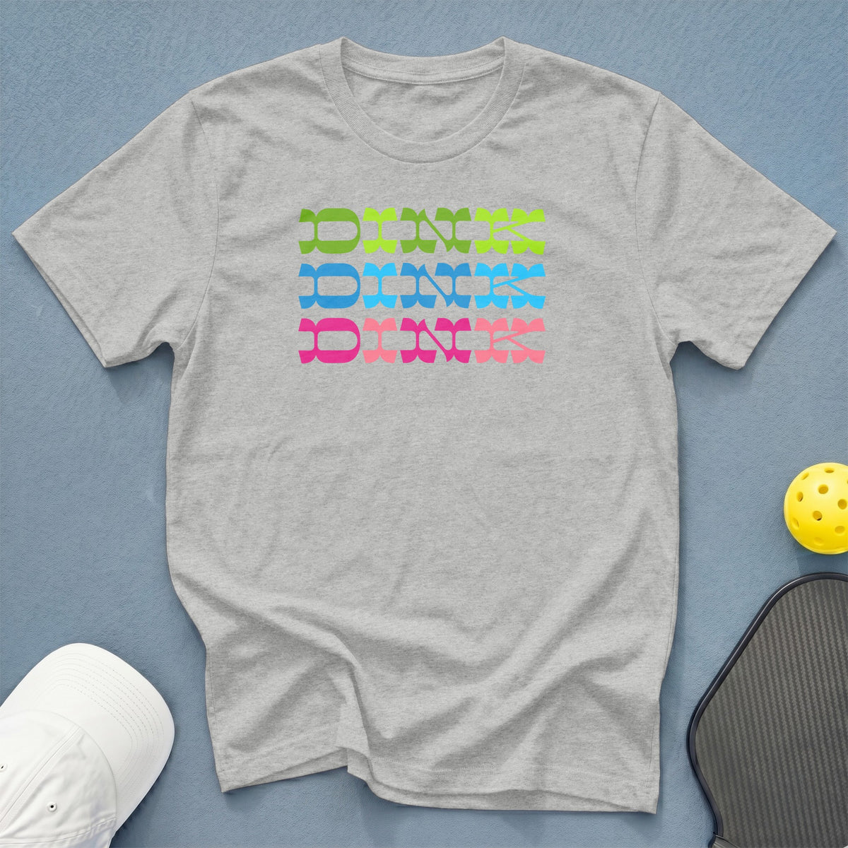 Gray t-shirt with colorful stacked "DINK" text and pickleball gear.