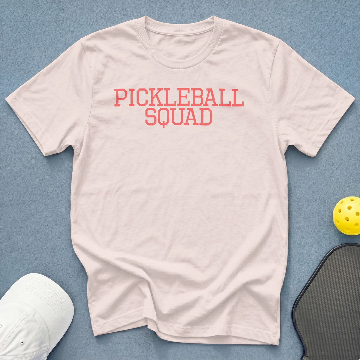 Light pink t-shirt with coral text reading "PICKLEBALL SQUAD".
