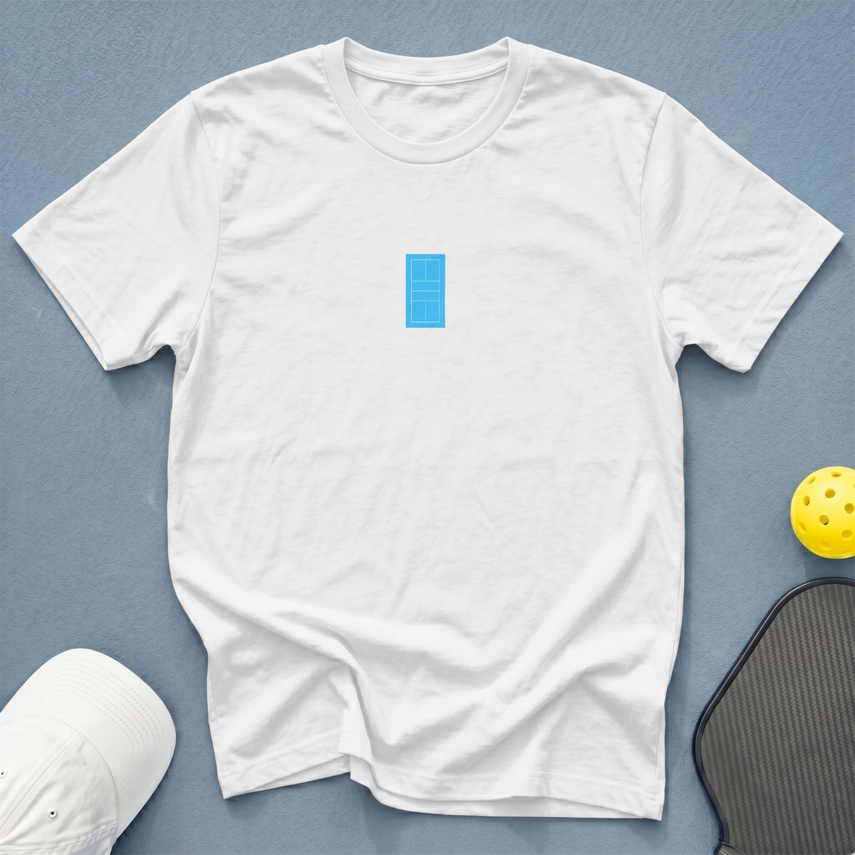 White t-shirt with a small blue pickleball court graphic on the chest.