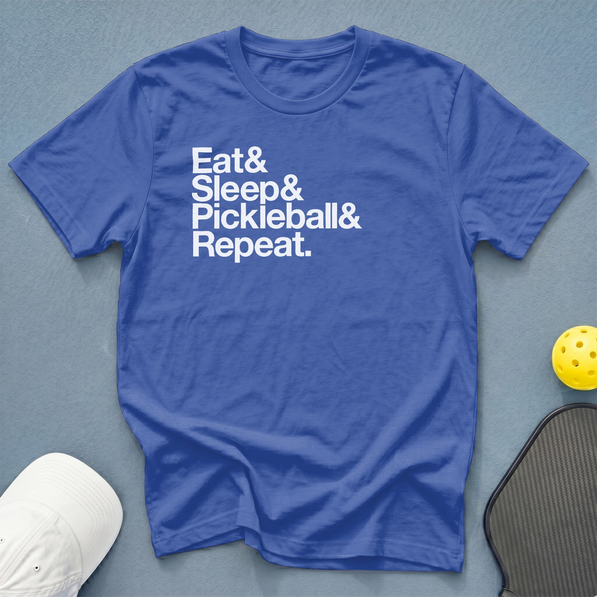 Blue t-shirt with white text reading "Eat & Sleep & Pickleball & Repeat."