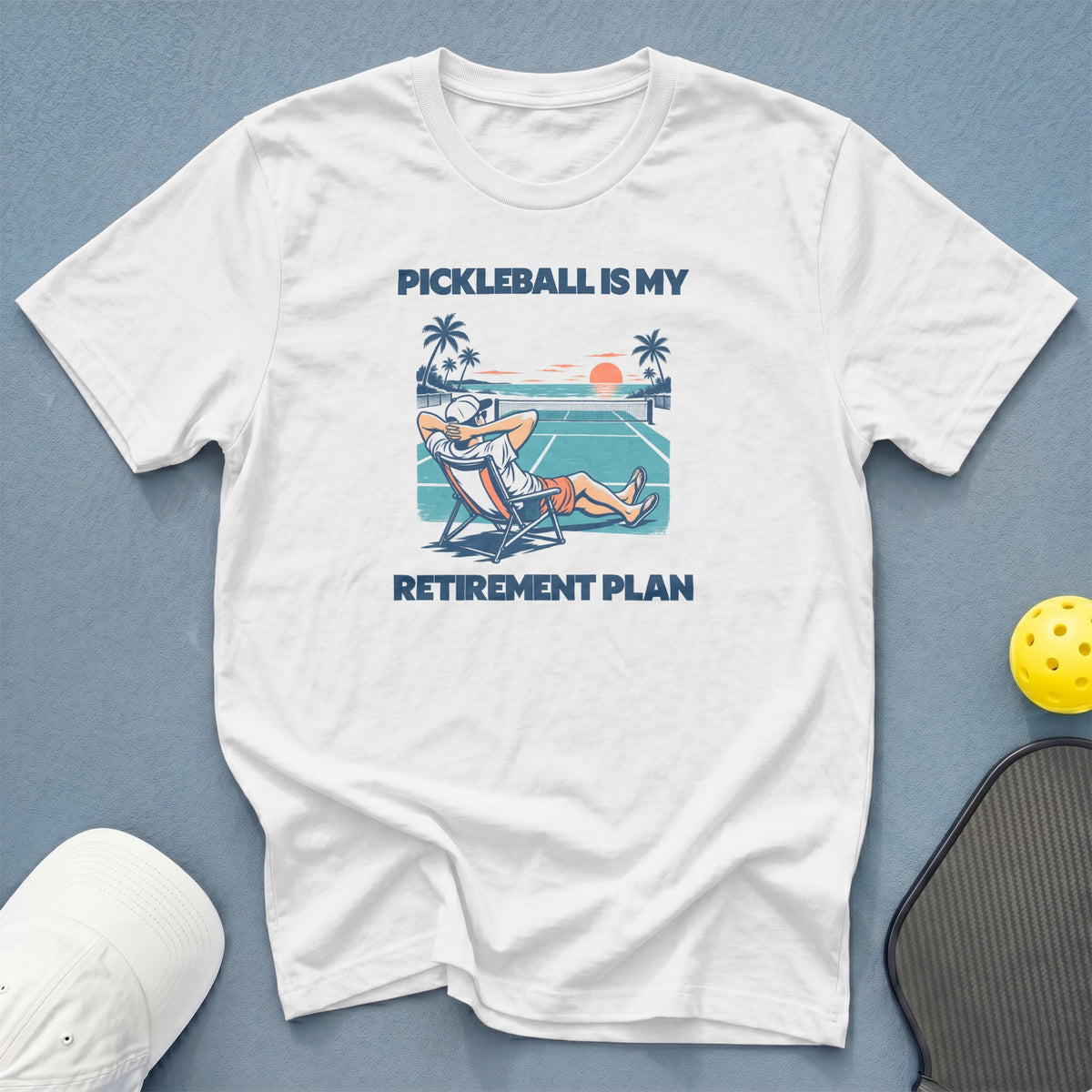 White t-shirt with "Pickleball is my retirement plan" graphic.