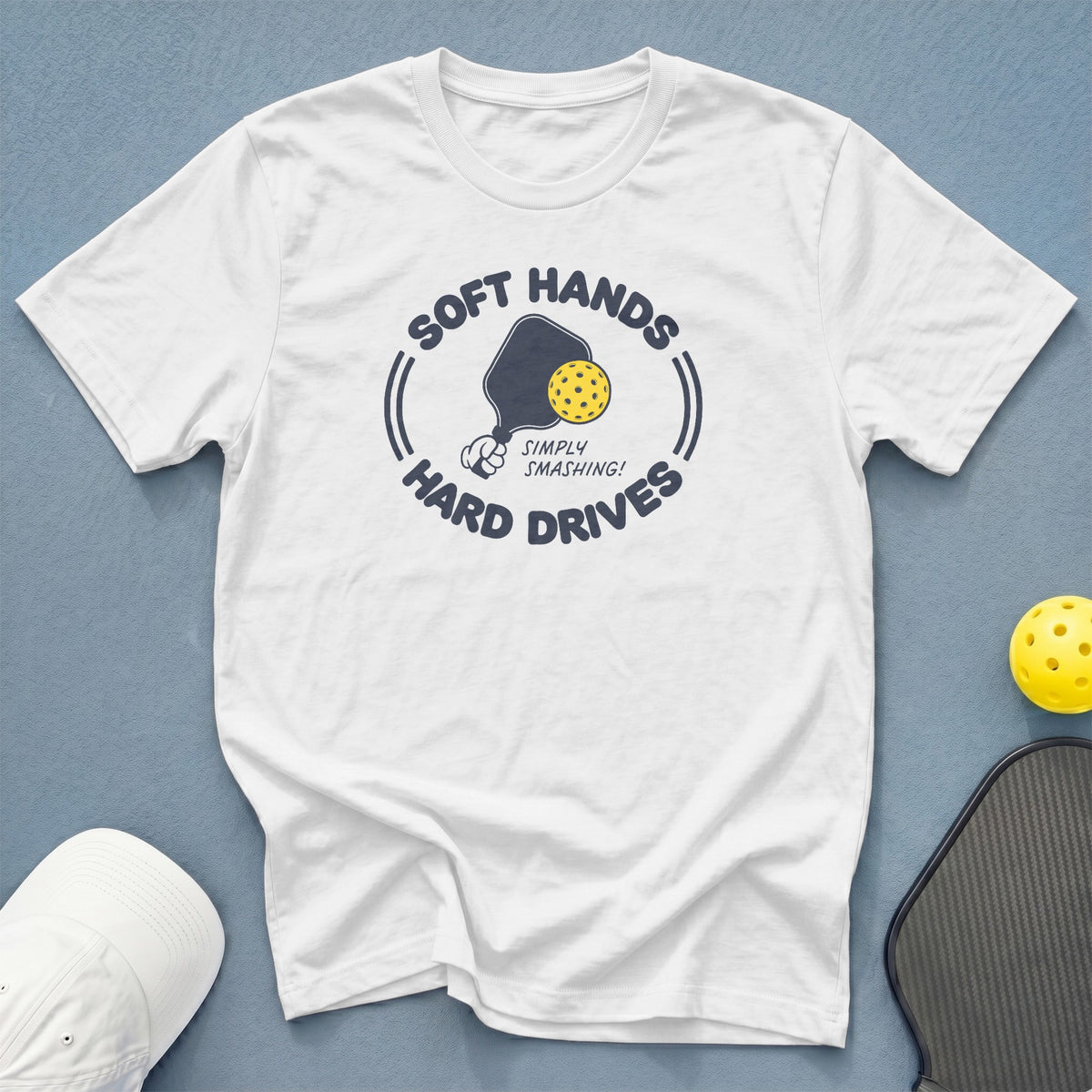 White t-shirt with pickleball graphic reading "Soft Hands Simply Smashing! Hard Drives".