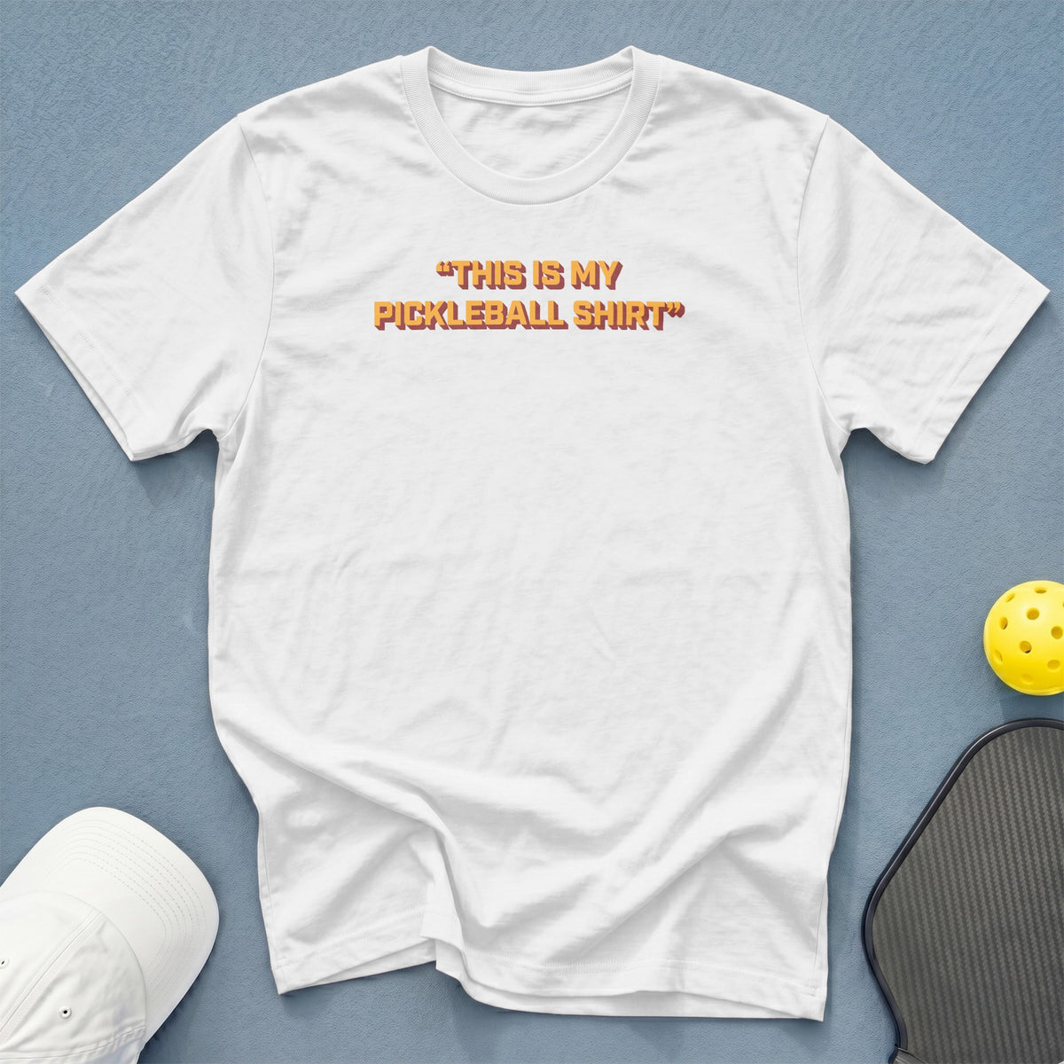 White t-shirt with orange text "This is my pickleball shirt".
