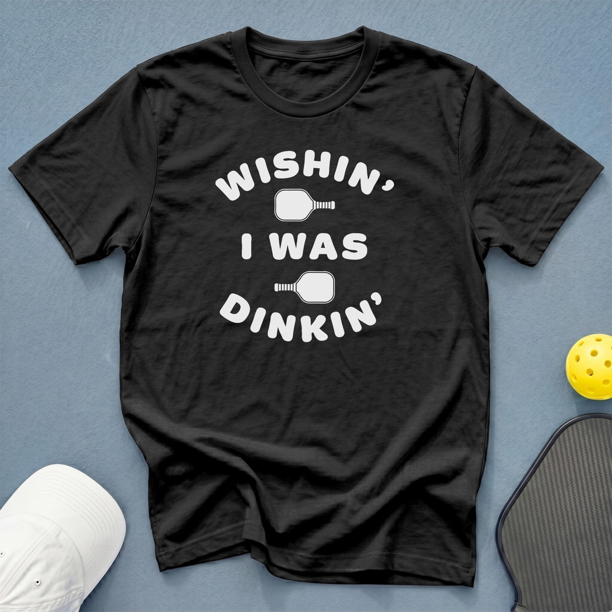 Black t-shirt with white text "Wishin', I Was Dinkins" and pickleball graphics.