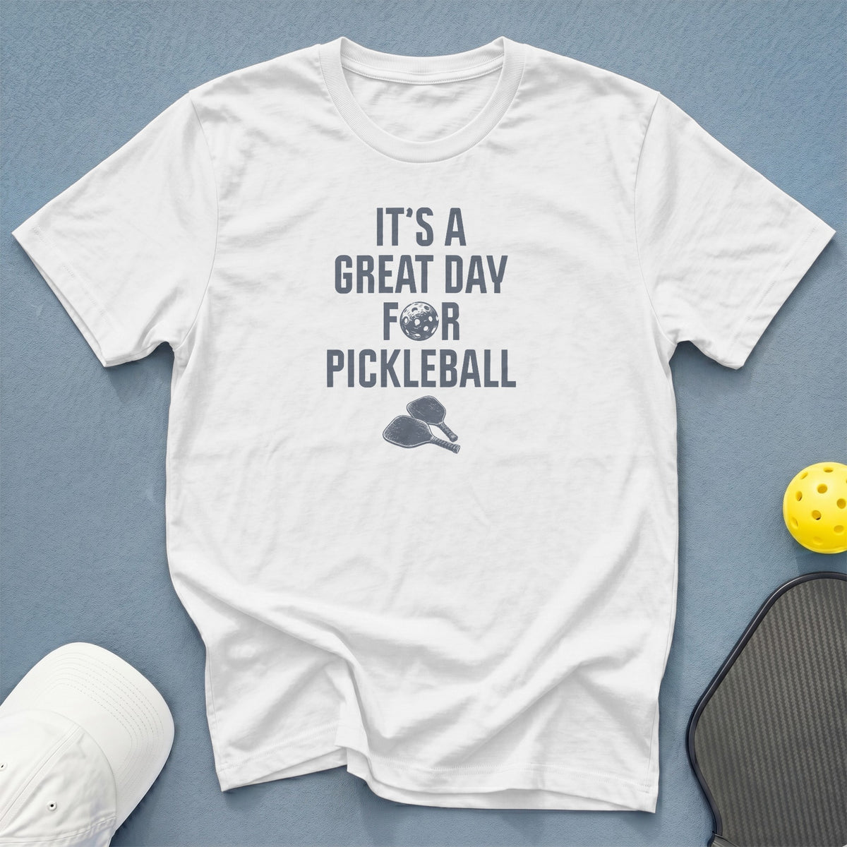 White t-shirt with "IT'S A GREAT DAY FOR PICKLEBALL" text and pickleball graphics.