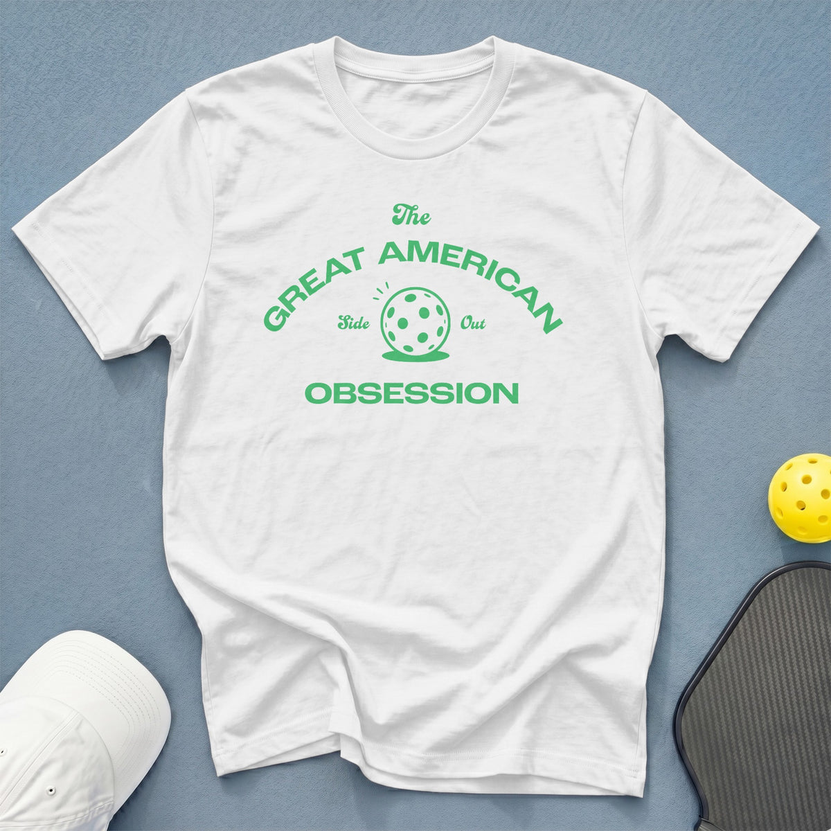 White t-shirt with "The Great American Pickleball Obsession" text and pickleball graphic.