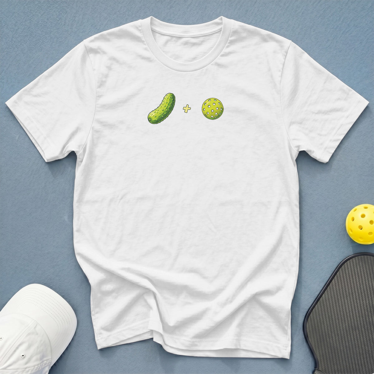 White t-shirt with pickle and pickleball graphic, plus accessories.