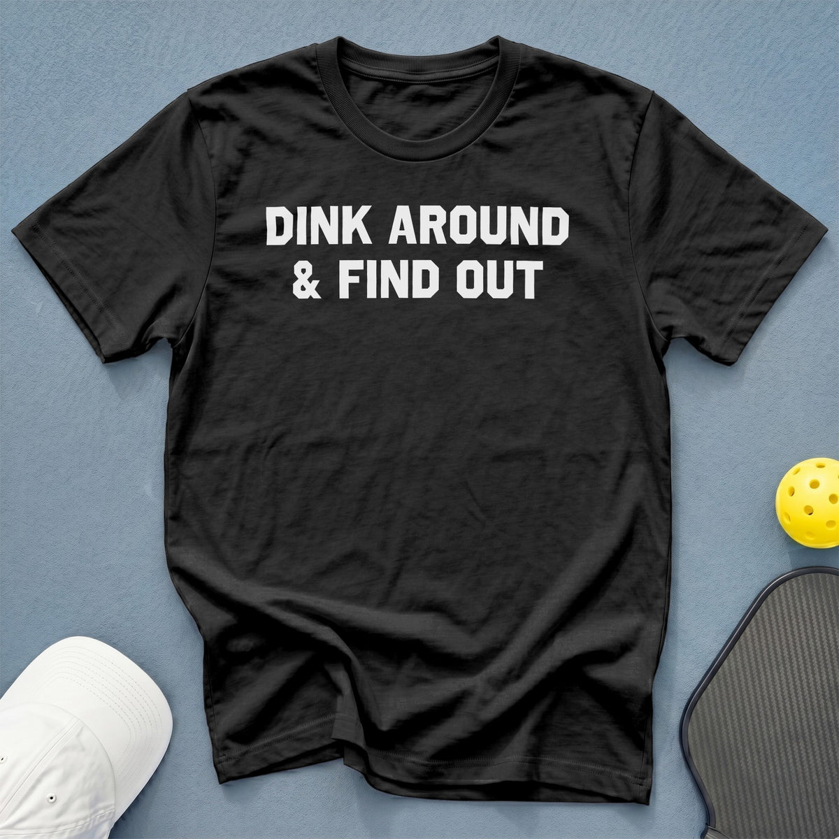 Black t-shirt with white text "DINK AROUND & FIND OUT".