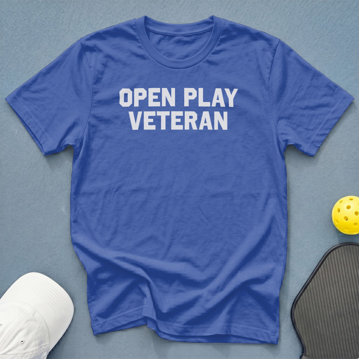 Blue t-shirt with white text "OPEN PLAY VETERAN"