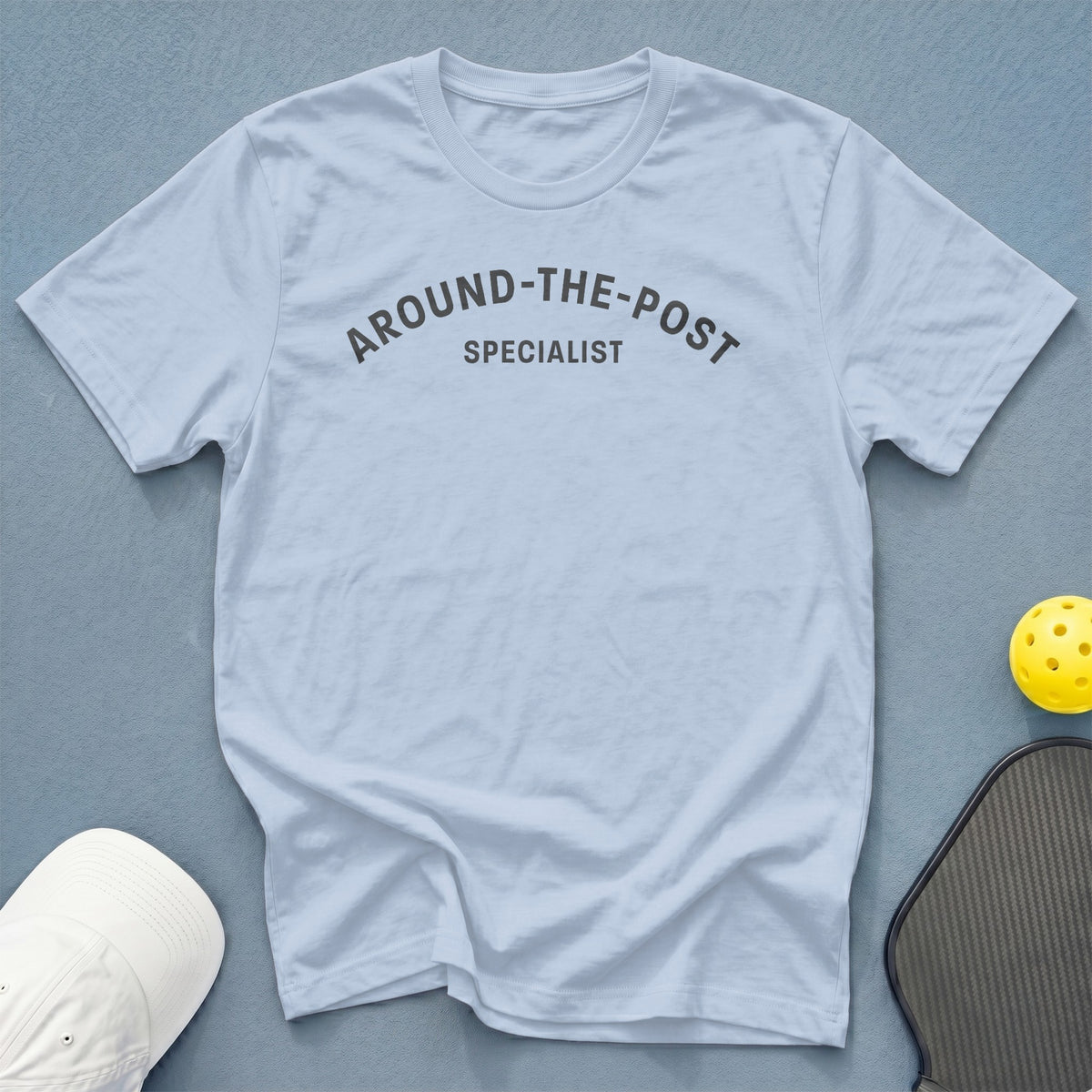 Light blue t-shirt with dark gray text reading "AROUND-THE-POST SPECIALIST".