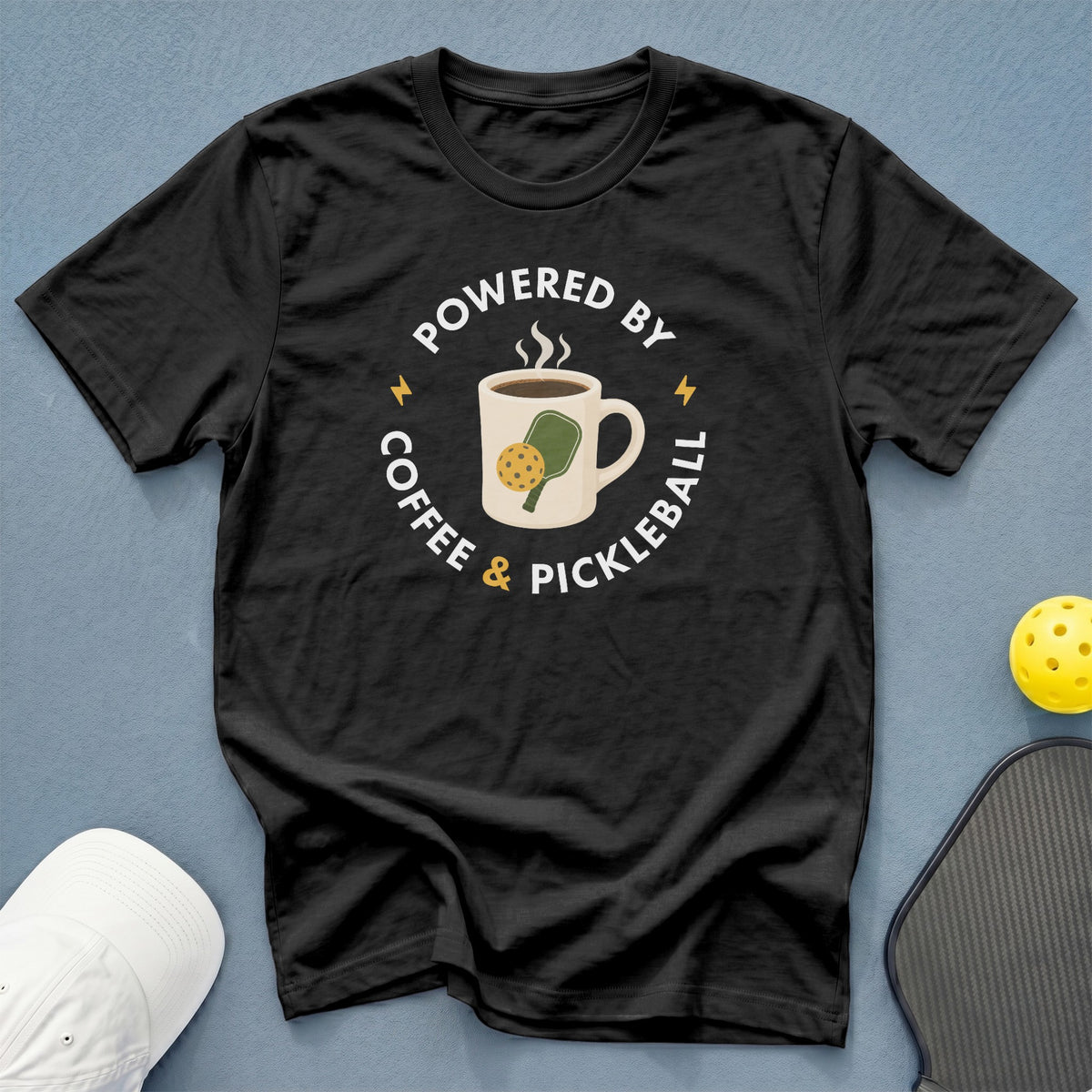 Black t-shirt with "Powered by Coffee & Pickleball" text and graphic.