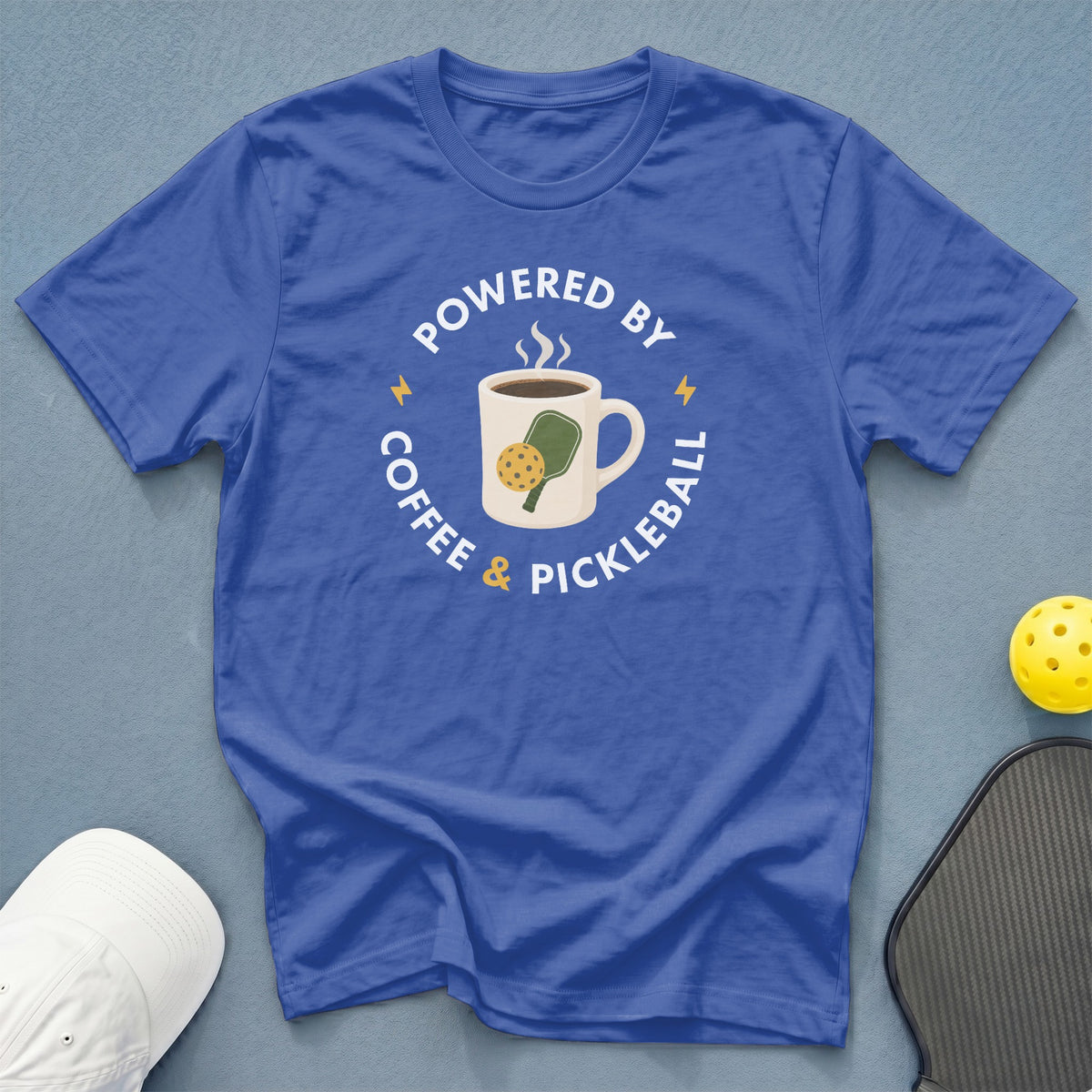 Blue t-shirt with "Powered by Coffee & Pickleball" text and graphic.
