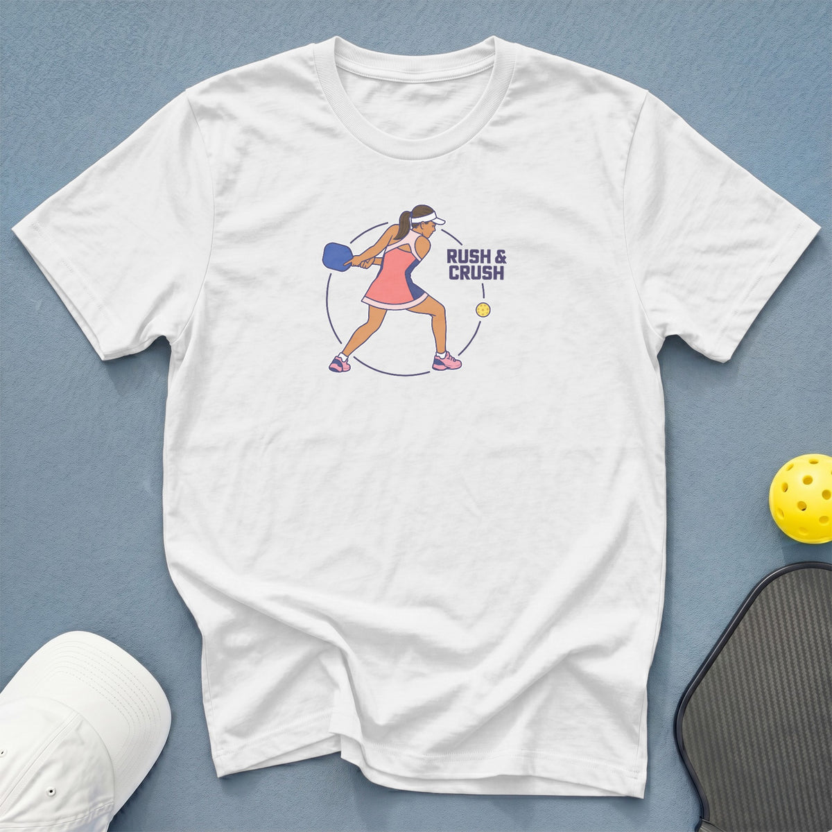 White t-shirt with pickleball player graphic and text "RUSH & CRUSH".