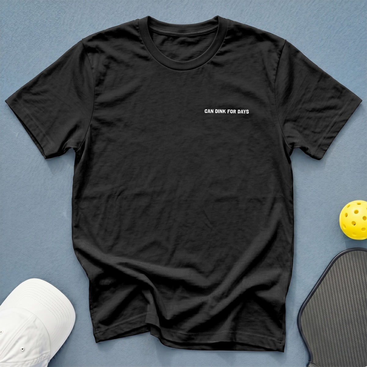 Black t-shirt with "CAN DINK FOR DAYS" text, pickleball paddle, and ball.