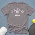 Gray t-shirt with "Pickleball Est. At The Kitchen" text and pickleball paddles graphic.