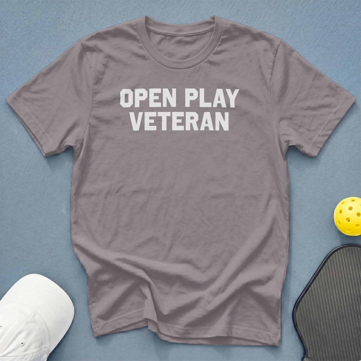 Gray t-shirt with "OPEN PLAY VETERAN" text, pickleball paddle, and ball.