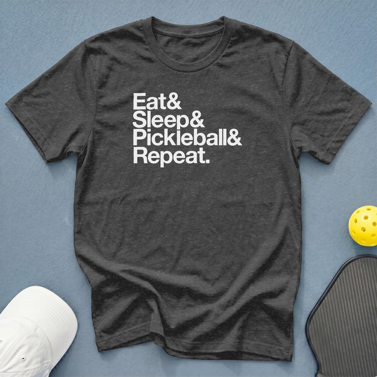 Dark grey t-shirt with white text "Eat & Sleep & Pickleball & Repeat."