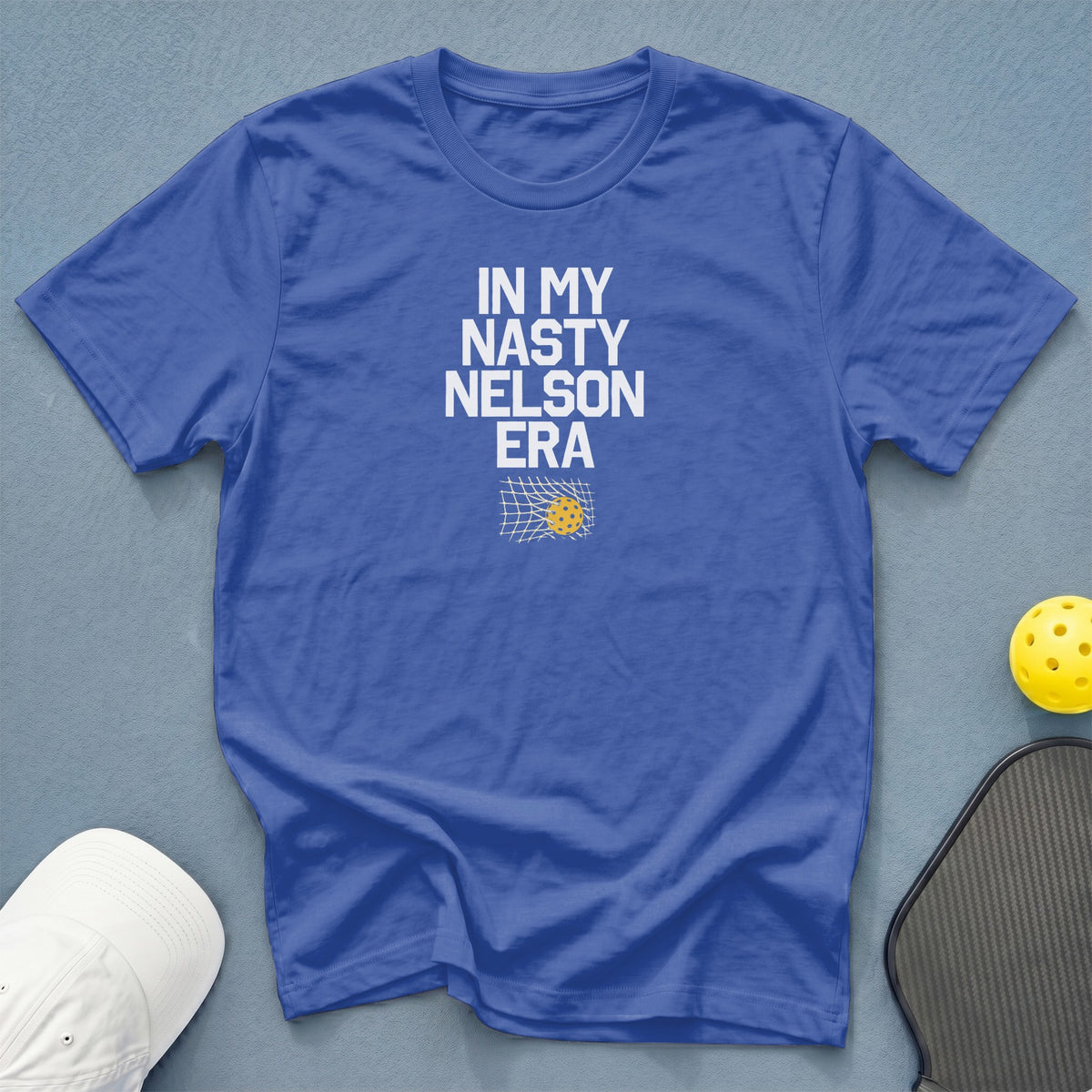 Blue t-shirt with white text "IN MY NASTY NELSON ERA" and pickleball graphics.