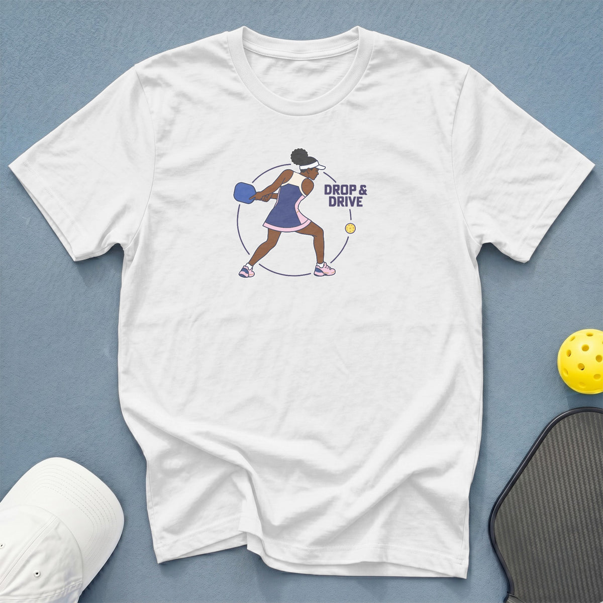 White t-shirt with pickleball player graphic and "Drop & Drive" text.