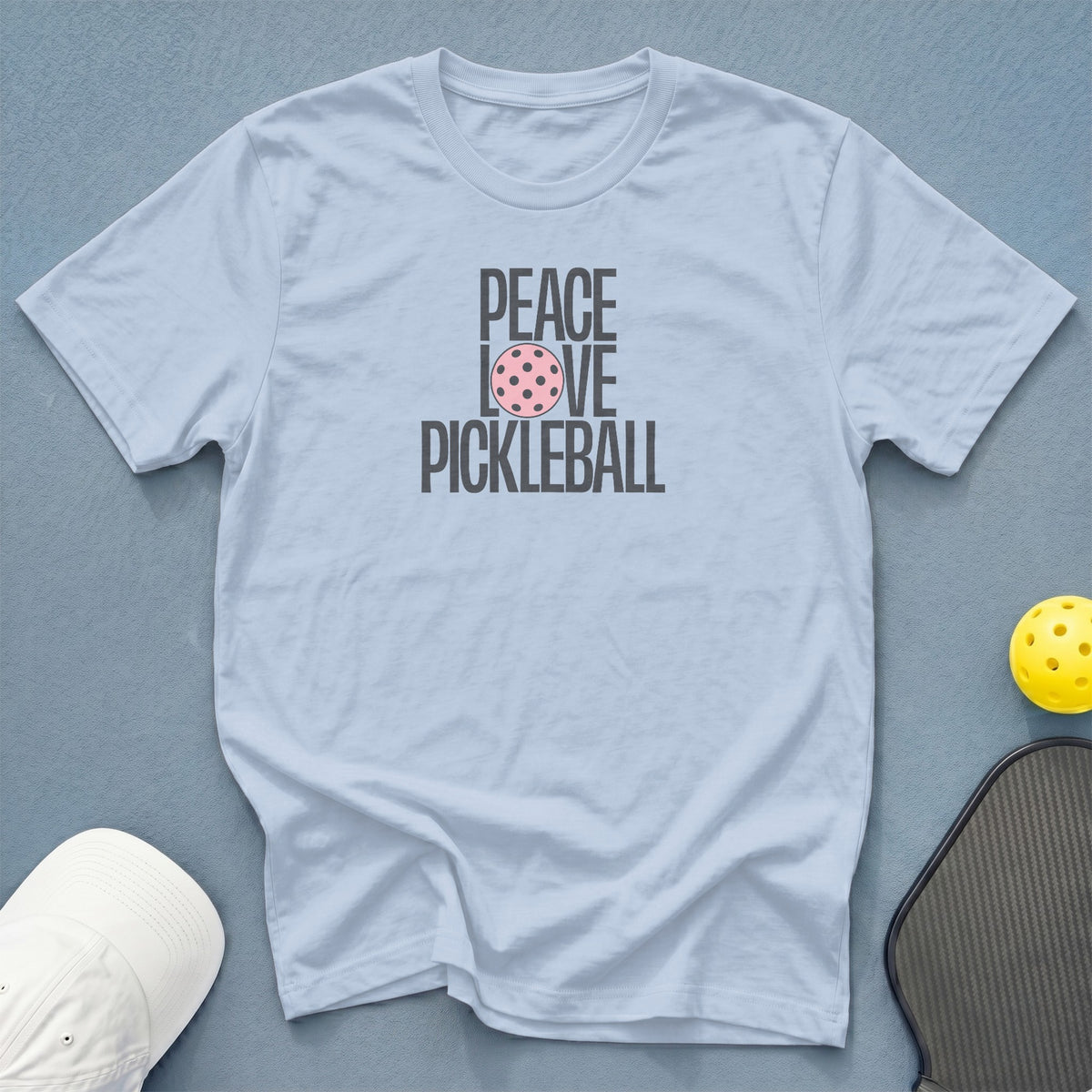 Light blue t-shirt with "Peace Love Pickleball" graphic and a pickleball.