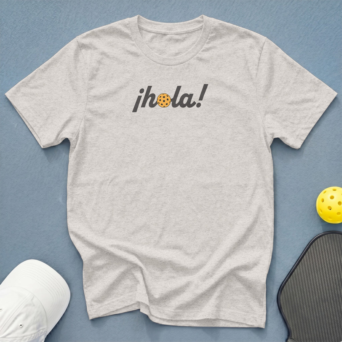 Light grey t-shirt with "¡Hola!" text and a pickleball graphic.