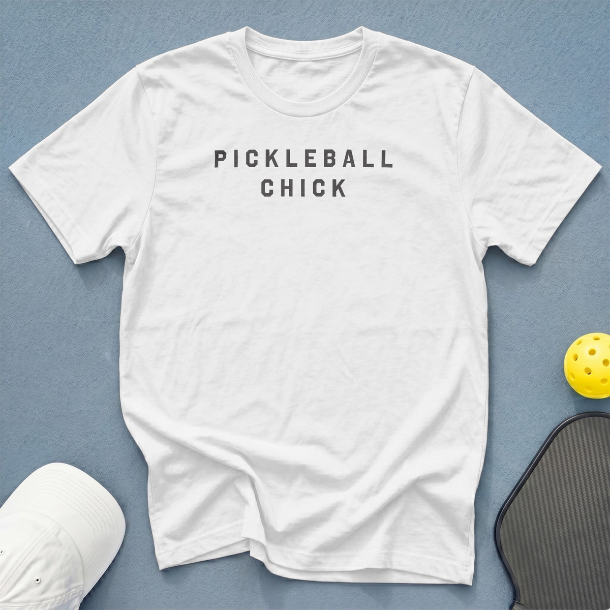 White t-shirt with "PICKLEBALL CHICK" text, pickleball paddle, and ball.