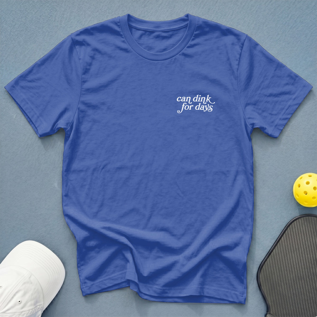 Blue t-shirt with "can dink for days" text and pickleball gear.