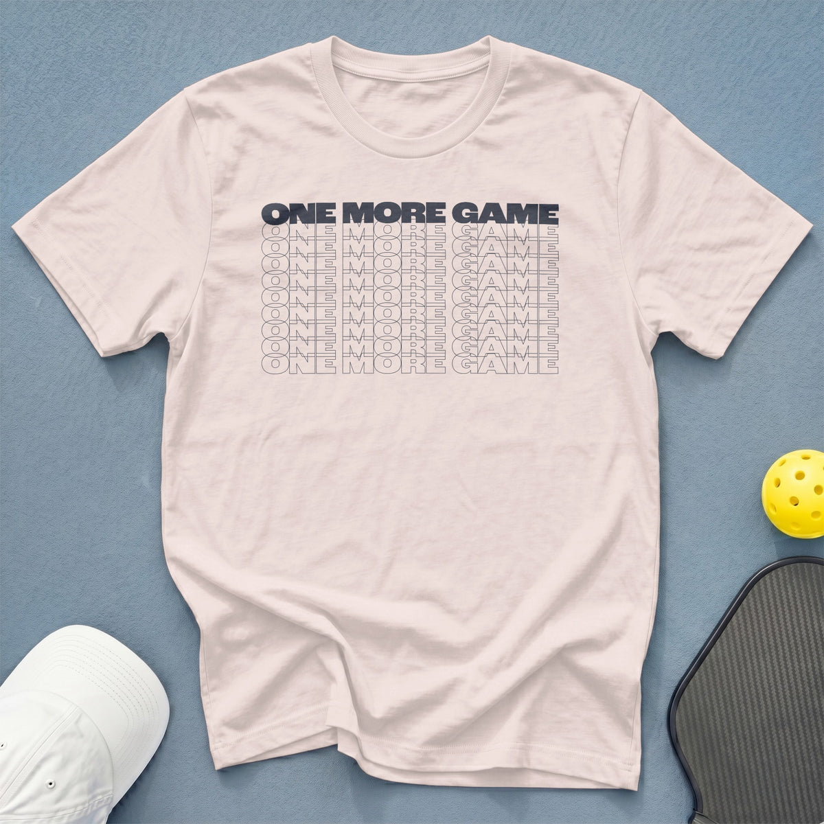 White t-shirt with "ONE MORE GAME" repeated in a gradient font.