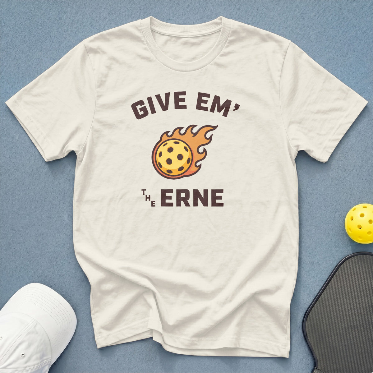 Cream t-shirt with "Give Em' The Erne" pickleball graphic and flaming pickleball.