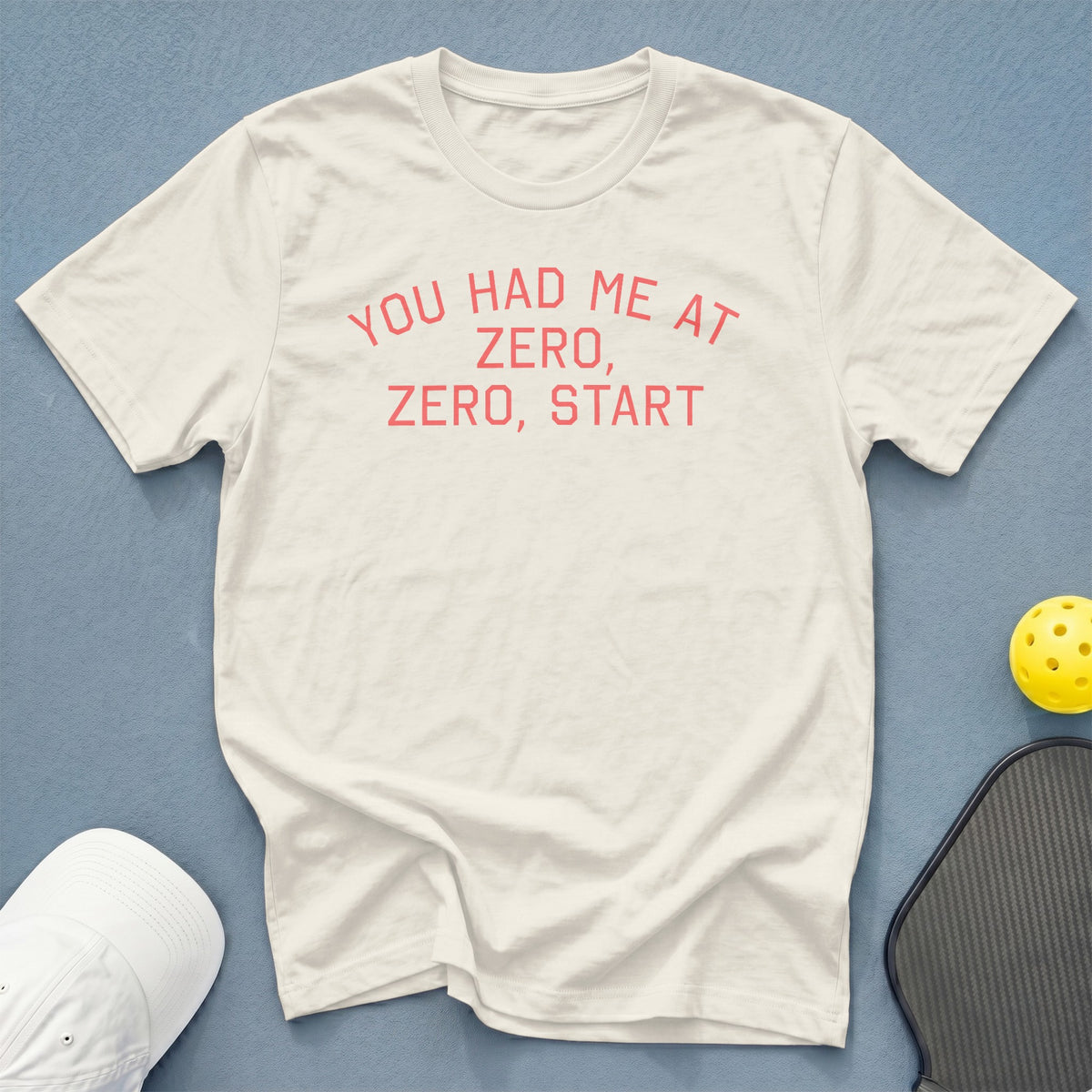 Cream t-shirt with pink text: "YOU HAD ME AT ZERO, ZERO, START"