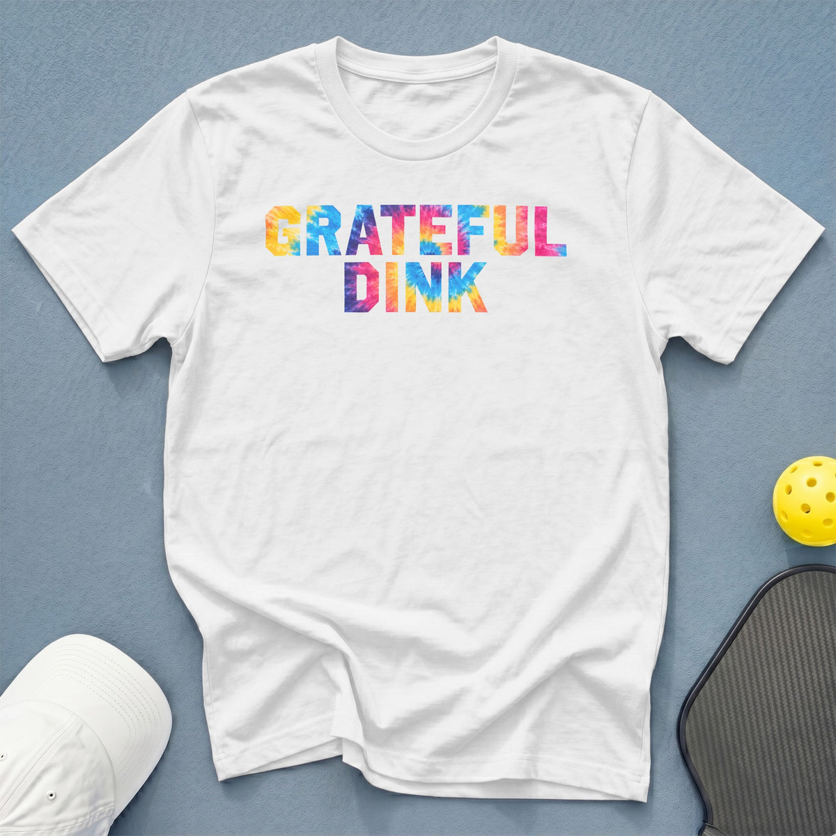 White t-shirt with tie-dye "GRATEFUL DINK" text.