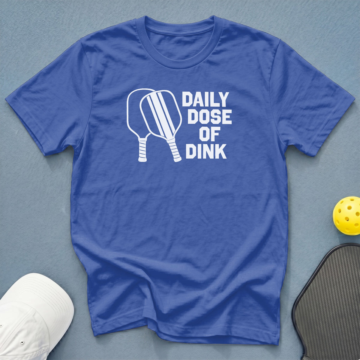 Blue t-shirt with "Daily Dose of Dink" and pickleball paddles graphic.