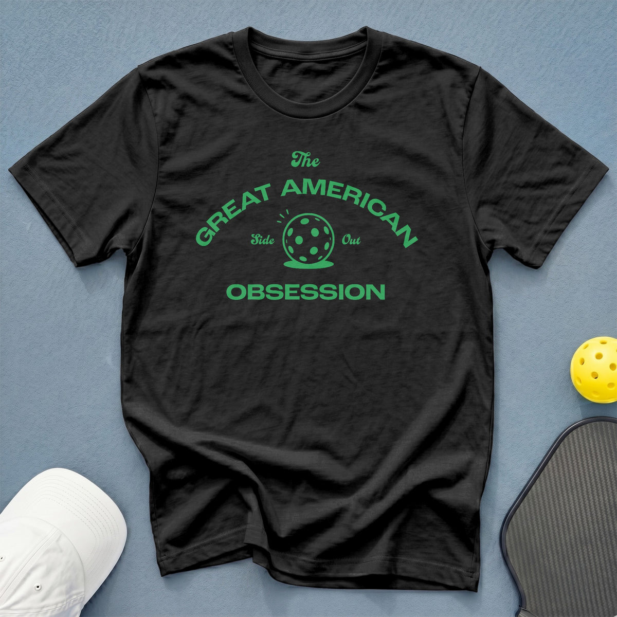 Black t-shirt with green text and pickleball graphic reading "The Great American Side Out Obsession."
