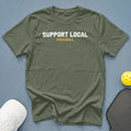 Olive green t-shirt with "SUPPORT LOCAL PICKLEBALL" graphic, pickleball, and hat.