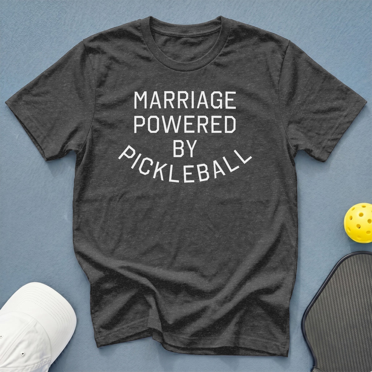 Dark gray t-shirt with white text "MARRIAGE POWERED BY PICKLEBALL".
