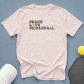 White t-shirt with "Peace Love Pickleball" text and pickleball graphic.