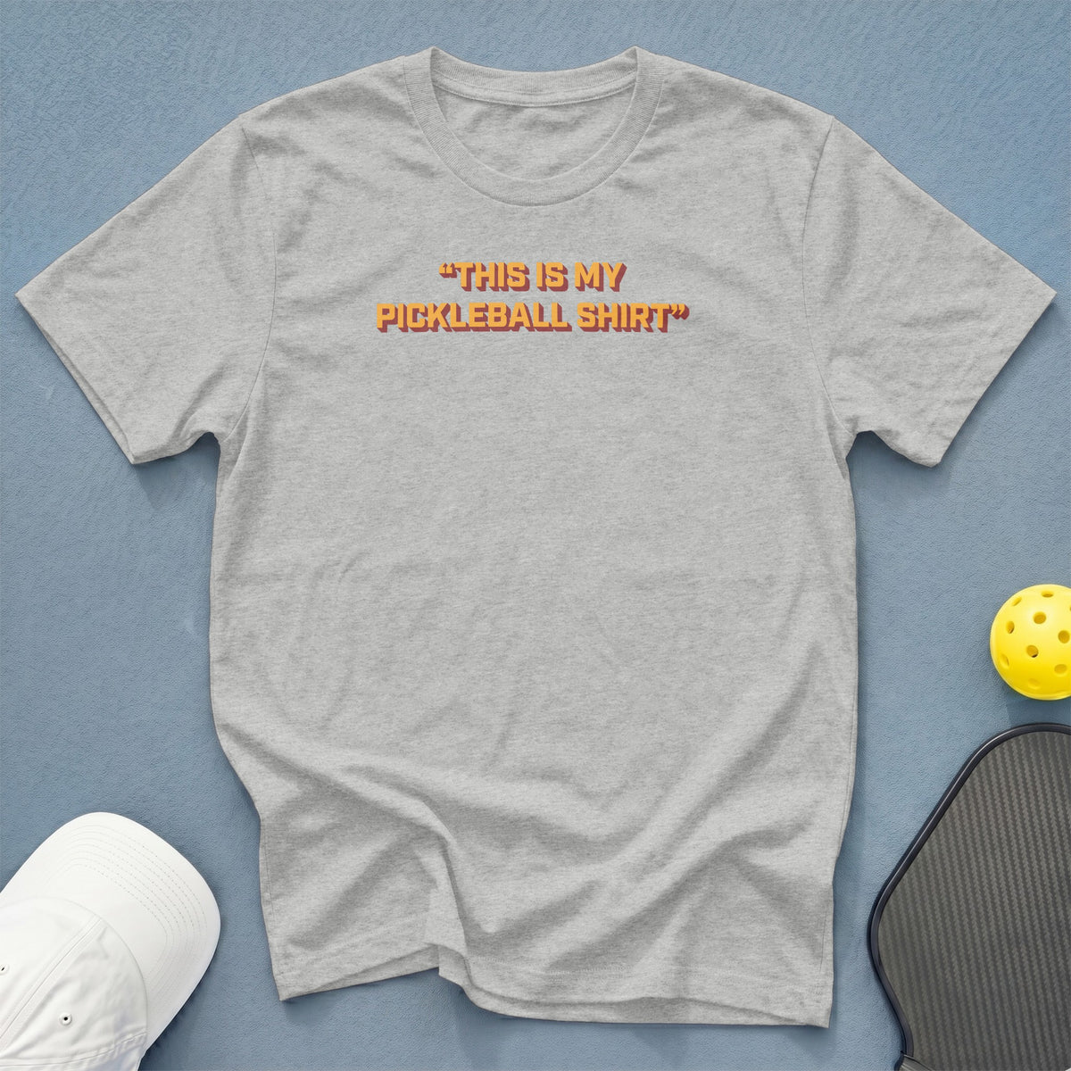 Light grey t-shirt with orange text "THIS IS MY PICKLEBALL SHIRT"