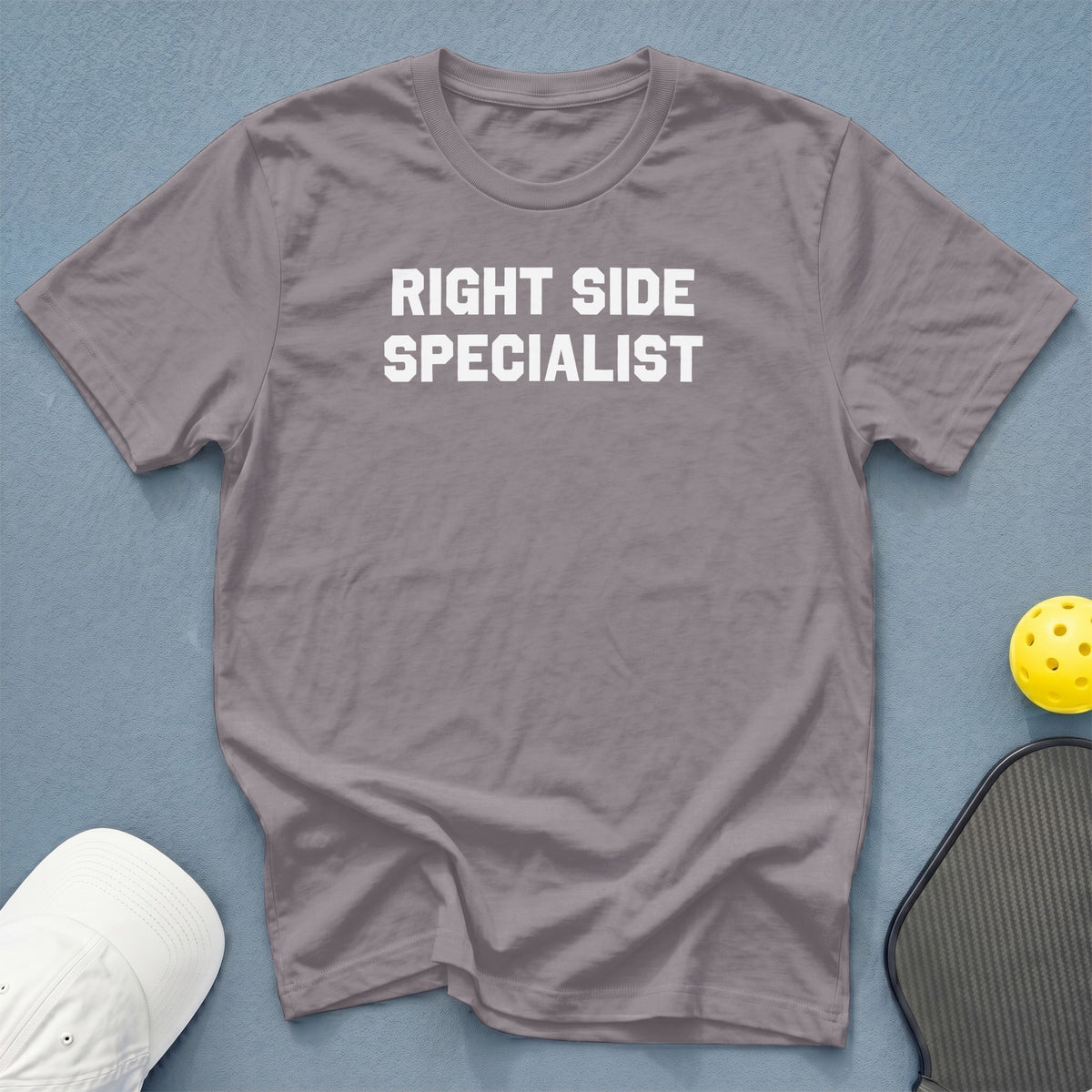 Grey t-shirt with white text "RIGHT SIDE SPECIALIST" next to pickleball equipment.