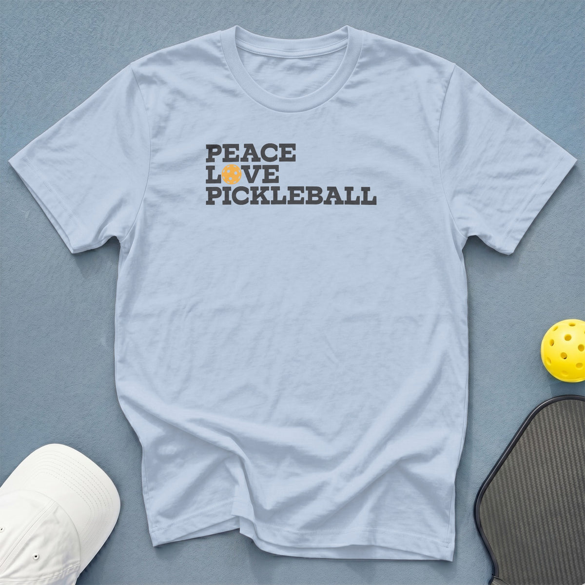 Light blue t-shirt with "Peace Love Pickleball" text and pickleball graphic.