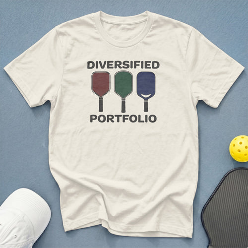 Cream t-shirt with "DIVERSIFIED PORTFOLIO" and three pickleball paddles graphic.
