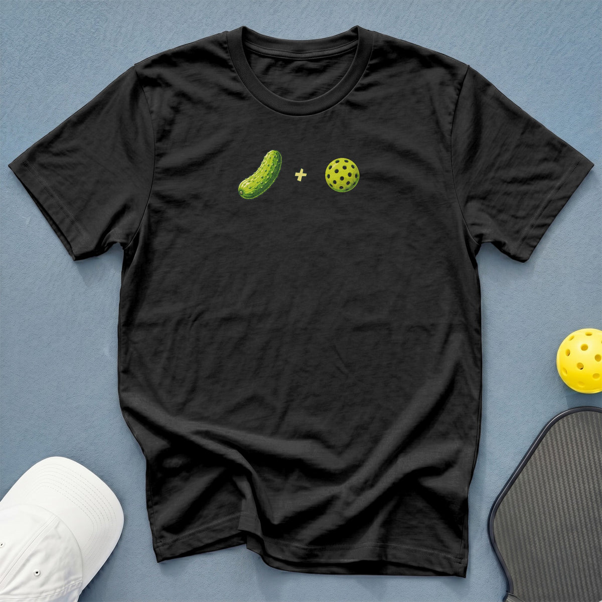 Black t-shirt with pickle and pickleball graphic, plus racquet and ball.
