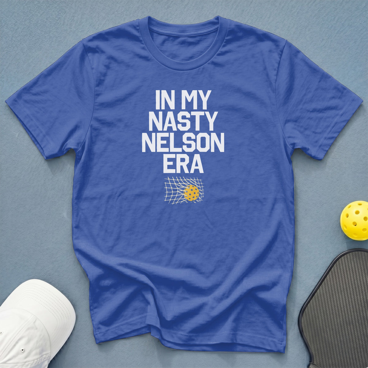 Blue t-shirt with white text: "IN MY NASTY NELSON ERA" and pickleball graphic.