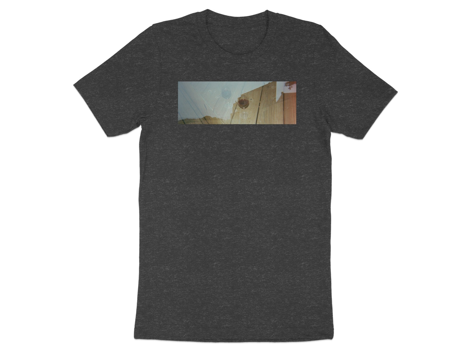Dark gray t-shirt with a horizontal image of a wine glass on a wooden surface.