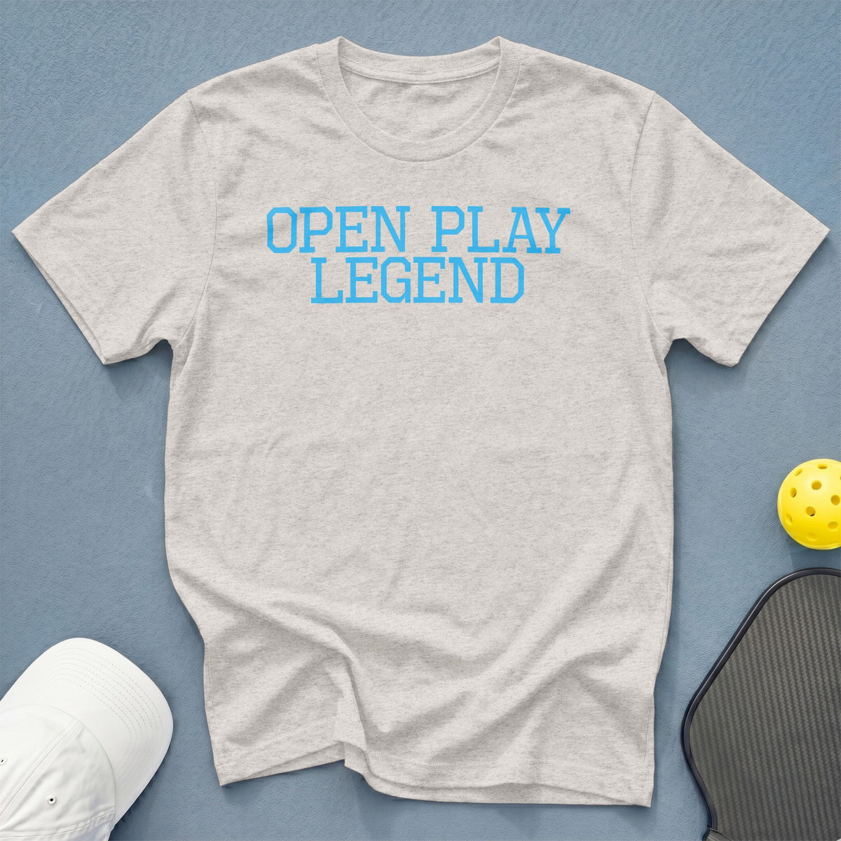 Light gray t-shirt with "OPEN PLAY LEGEND" in blue text.