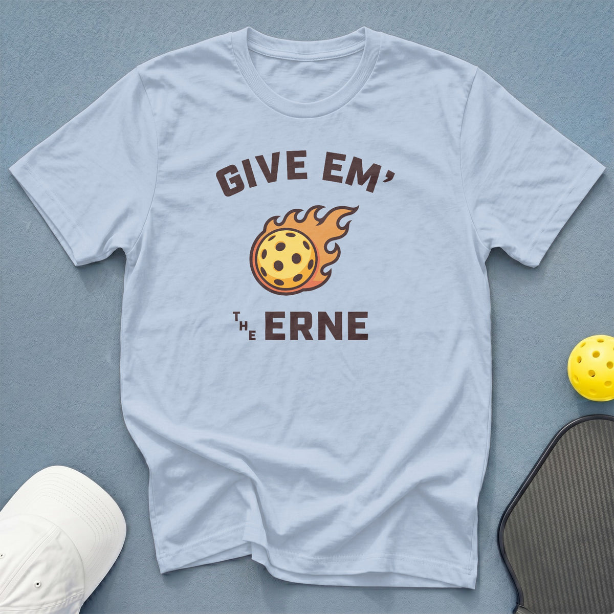Light blue t-shirt with graphic text "GIVE EM' THE ERNE" and a flaming pickleball.