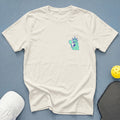 Cream t-shirt with cartoon Statue of Liberty holding pickleball paddle.