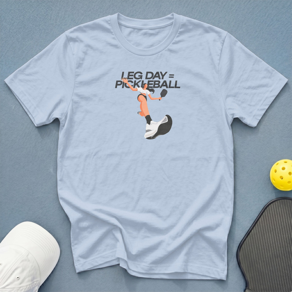 Light blue t-shirt with "LEG DAY = PICKLEBALL" text and pickleball player graphic.