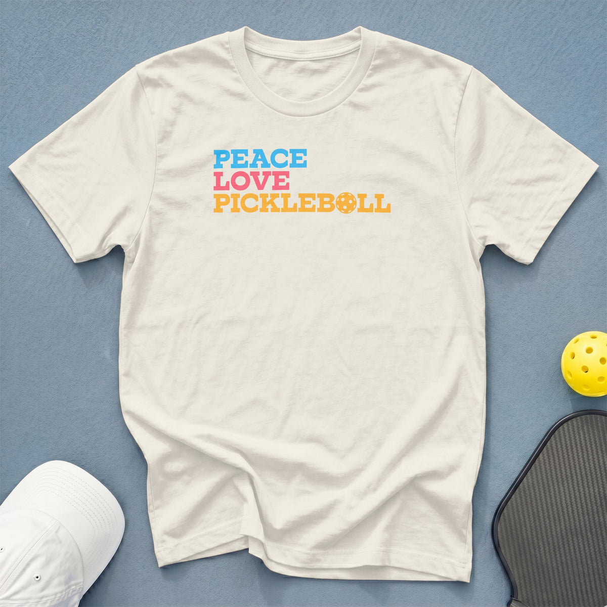 White t-shirt with "Peace Love Pickleball" text and pickleball graphic.
