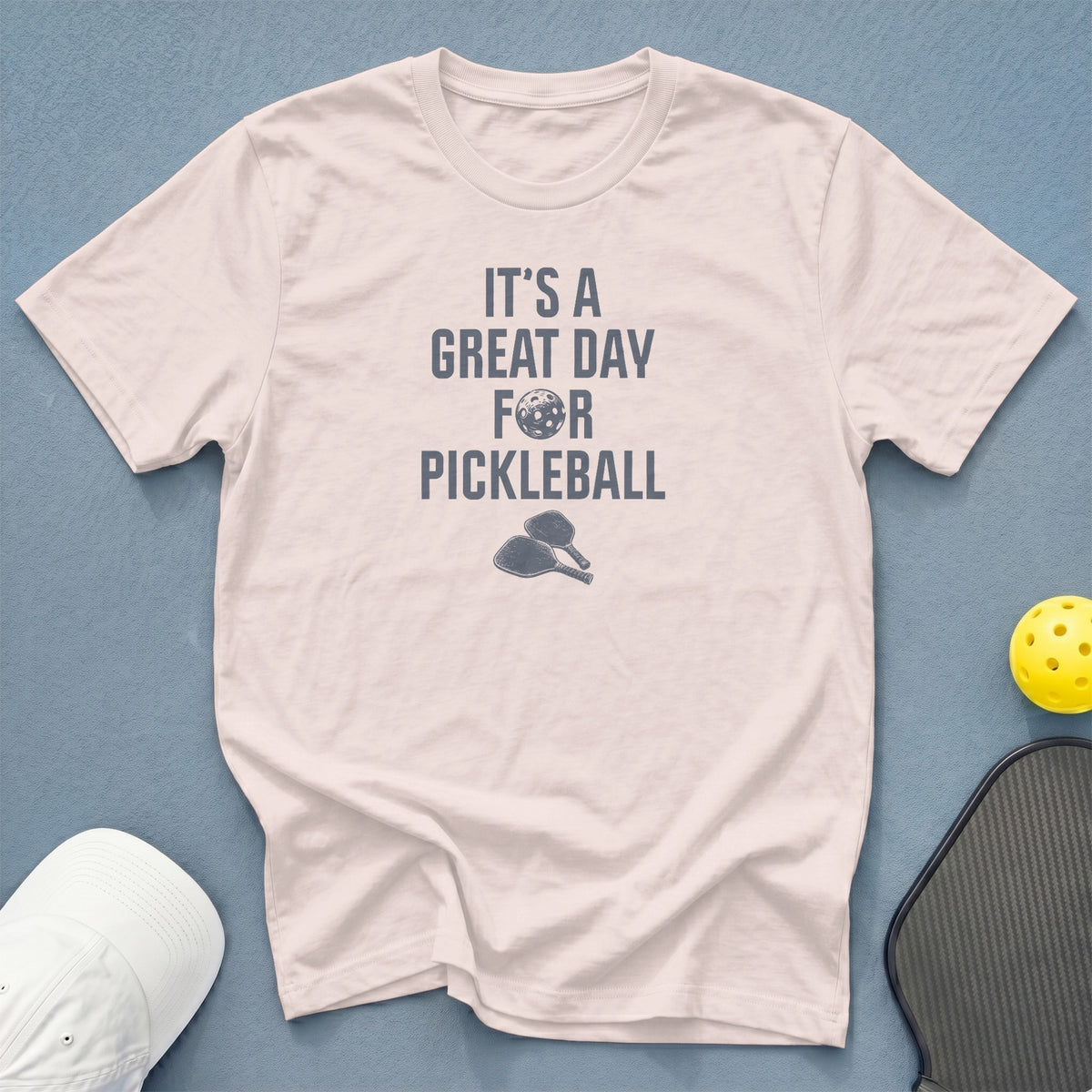 Light pink t-shirt with "It's a great day for pickleball" text and graphics.